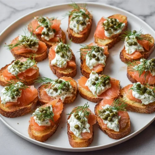 Delicious smoked salmon crostini topped with cream cheese and herbs